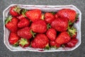 Delicious fragrant strawberries in a paper container. Red ripe berry is ready to eat. Top view. Close-up.