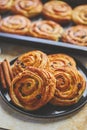 Delicious, fresh baked cinnamon buns served on black ceramic plate. With various sides Royalty Free Stock Photo