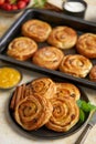 Delicious, fresh baked cinnamon buns served on black ceramic plate. With various sides Royalty Free Stock Photo