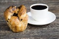 a delicious fresh bun and a cup of black aromatic coffee Royalty Free Stock Photo