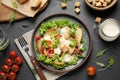 Delicious fresh Caesar salad on black table, flat lay Royalty Free Stock Photo