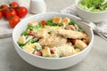 Delicious fresh Caesar salad in bowl on light grey table, closeup Royalty Free Stock Photo