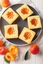 Delicious fresh cake stuffed with apricot close-up on a plate on the table. Vertical top view Royalty Free Stock Photo