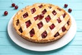 Delicious fresh cherry pie on blue wooden table, closeup Royalty Free Stock Photo