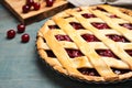 Delicious fresh cherry pie on light blue wooden table, closeup Royalty Free Stock Photo
