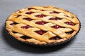 Delicious fresh cherry pie on grey wooden table, closeup Royalty Free Stock Photo