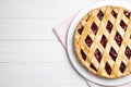 Delicious fresh cherry pie on white wooden table, flat lay. Space for text Royalty Free Stock Photo