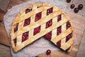 Delicious fresh cherry pie on wooden board, flat lay Royalty Free Stock Photo