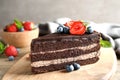 Delicious fresh chocolate cake with berries on wooden table Royalty Free Stock Photo