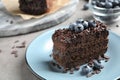 Delicious fresh chocolate cake with blueberries on table, closeup Royalty Free Stock Photo