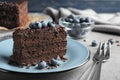 Delicious fresh chocolate cake served with blueberries on table Royalty Free Stock Photo