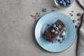 Delicious fresh chocolate cake served with blueberries on table, flat lay. Space for text Royalty Free Stock Photo