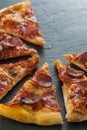 Delicious fresh cooked slices of pepperoni pizza on slate
