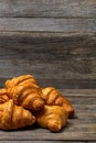 Delicious, fresh croissants isolated on wooden board. French breakfast concept