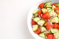 Delicious fresh cucumber tomato salad in bowl on table, top view Royalty Free Stock Photo