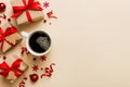 Delicious fresh festive morning coffee in a ceramic cup with little wrapped gifts, ornament and xmas toy. Cup of coffee