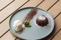 Delicious fresh fondant with hot chocolate and ice cream and mint served on plate. Lava cake recipe. Wooden background. Royalty Free Stock Photo