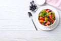 Delicious fresh fruit salad in bowl on white wooden table, flat lay. Space for text Royalty Free Stock Photo