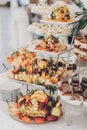 Delicious fresh fruits on stand on table at wedding reception in restaurant. Luxury catering service. Wedding healthy fruit bar. Royalty Free Stock Photo