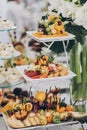Delicious fresh fruits on stand on table at wedding reception in restaurant. Luxury catering service. Wedding healthy fruit bar. Royalty Free Stock Photo