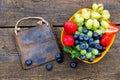 Delicious fresh fruits on a wooden table, rusty metal sign Royalty Free Stock Photo