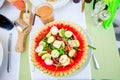 Delicious fresh greek salad served for lunch in watermelon at outdoor restaurant Royalty Free Stock Photo