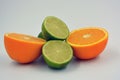 Healthy ripe delicious fruits for human health. Juicy fruits of orange orange, lime with bright green mint. Two halves of an orang Royalty Free Stock Photo