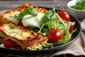 Delicious fresh homemade lasagna with salad and bread