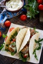 Delicious fresh homemade tortilla wrap with falafel and fresh salad on the table. Vegan tacos. Royalty Free Stock Photo