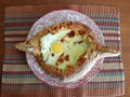 Delicious fresh Khachapuri prepared for lunch by a grandmother in the village
