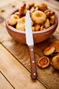 Delicious fresh lactarius mushrooms straight from the forest in a brown bowl and a knife