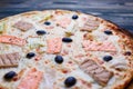 Delicious fresh mediterranean fish pizza with salmon, tuna and o Royalty Free Stock Photo