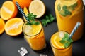 Delicious fresh orange juice with ice, mint and fresh fruits on black table background Royalty Free Stock Photo