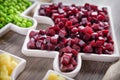 Delicious Fresh pieces of beet cube close-up with fresh onion and olive oil on a bag cloth on a rustic gray table.