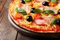 Delicious fresh pizza on brown wooden background Royalty Free Stock Photo