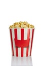 Delicious fresh popcorn in paper striped bucket Royalty Free Stock Photo