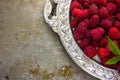 Delicious Fresh raspberries in vintage silver plate vitamins healthy food vegan ingredients. Selective focus Royalty Free Stock Photo