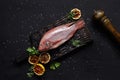 Delicious fresh raw red seafood fish mullet on dark table, top view Royalty Free Stock Photo