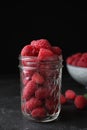 Delicious fresh ripe raspberries in glass jar on table Royalty Free Stock Photo