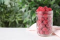Delicious fresh ripe raspberries in glass jar on white wooden table. Space for text Royalty Free Stock Photo