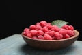 Delicious fresh ripe raspberries in plate on wooden table Royalty Free Stock Photo