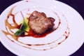 Delicious fresh sliced, pan seared Foie Gras with berry sauce decoration served on white porcelain plate. Duck or Goose Fattened