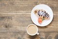 Freshly baked chocolate croissants and cup of coffee on wooden board. Top view. Female breakfast concept. Copy space. Royalty Free Stock Photo