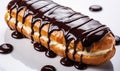 Delicious Freshly Baked Eclair with Smooth Shiny Chocolate Glaze Drizzled Over the Top Isolated on a White Background