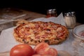 Delicious freshly baked Hawaiian pizza on a wooden table Royalty Free Stock Photo