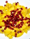 Delicious freshly cut mango with pomegranate seeds. Healthy snack idea. Healthy food. Isolated on white background Royalty Free Stock Photo