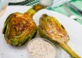 Delicious fried artichoke halves with coarse salt on a white plate Royalty Free Stock Photo