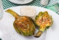 Delicious fried artichoke halves with coarse salt on a white plate Royalty Free Stock Photo