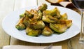 Delicious fried artichoke halves on a white plate Royalty Free Stock Photo