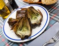 Delicious fried artichoke halves on a white plate Royalty Free Stock Photo